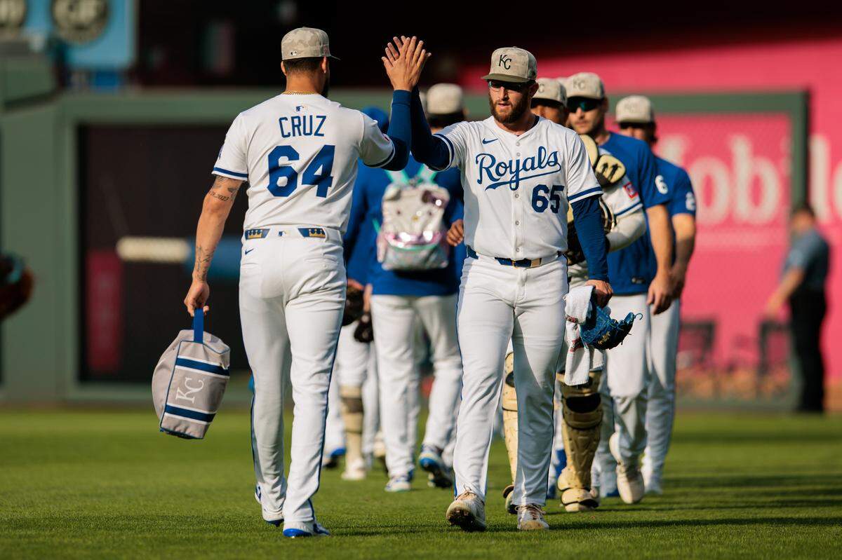 Kansas City Royals pitcher Steven Cruz (64) slaps hands with Kansas City Royals pitcher Noah Cameron (65) prior to the game against the St. Louis Cardinals at Kauffman Stadium on May 17, 2025 in Kansas City, Missouri, USA.