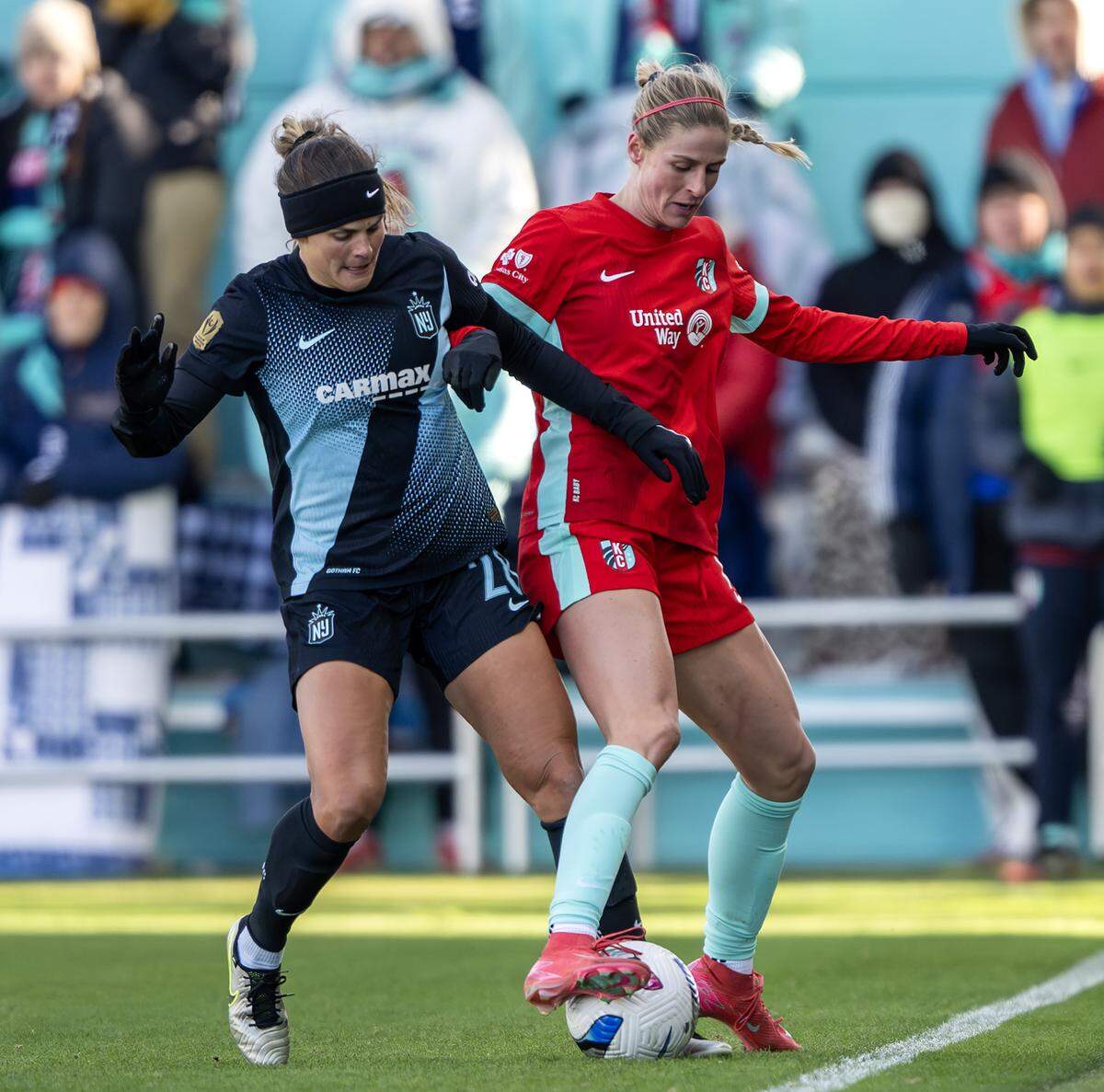 Gotham FC forward Katie Stengel, left, fights KC Current forward Haley Hopkins for possession during an NWSL quarterfinal playoff match at CPKC Stadium in Kansas City on Sunday, Nov. 9, 2025.