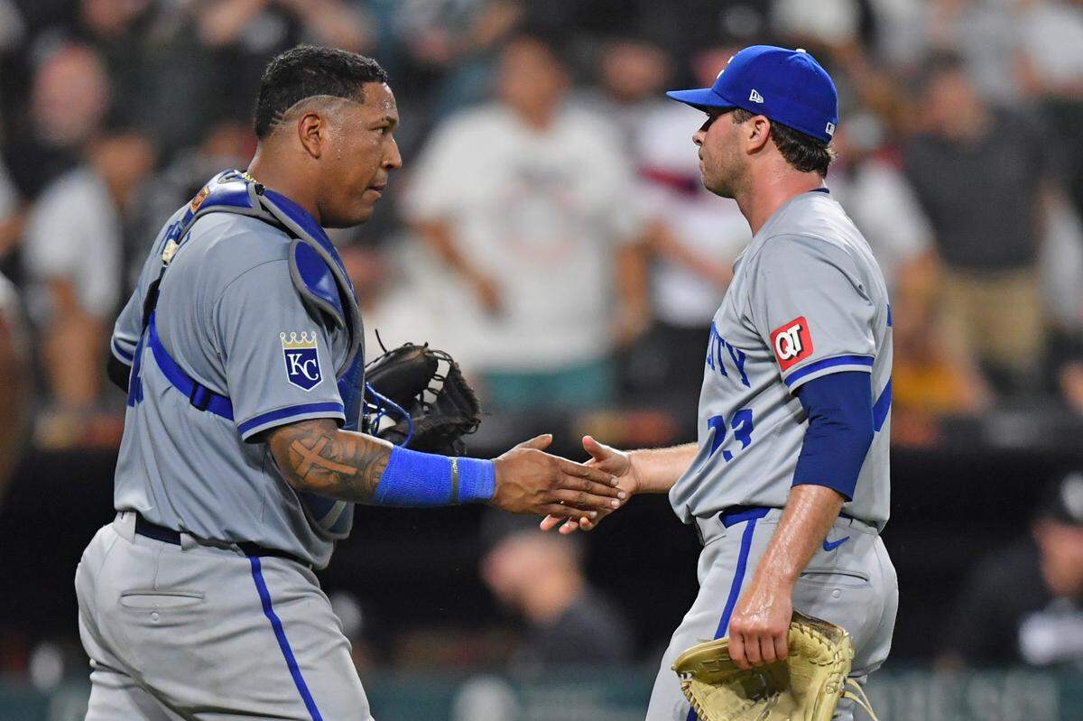 Kansas City Royals catcher Salvador Perez (left) celebrates with relief pitcher Sam Long (right) after defeating the Chicago White Sox at Guaranteed Rate Field on July 30, 2024, in Chicago.