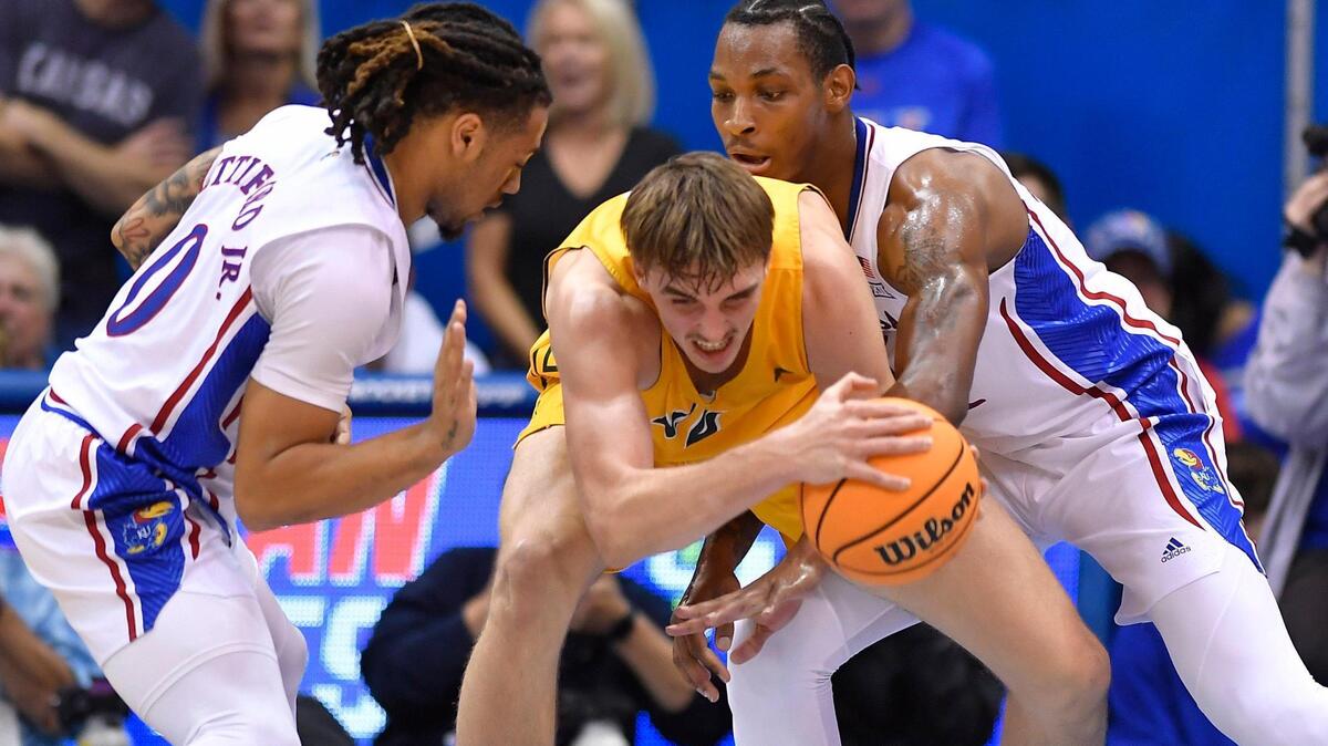 KU’s Bobby Pettiford, left, and teammate MJ Rice double up NDSU’s Grant Nelson during the second half of Thursday night’s game at Allen Fieldhouse. KU beat North Dakota State, 82-59.