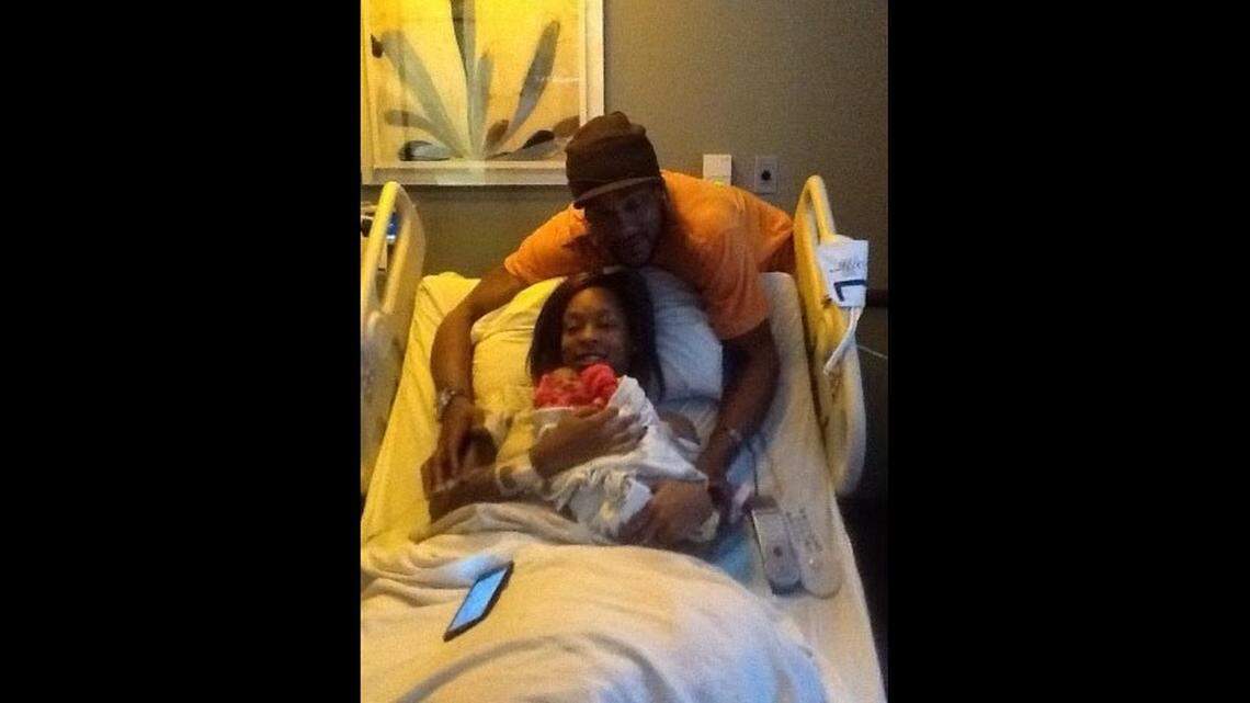 Joseph Burns poses with his daughter Janeasa Burns after she gave birth to one of her two children. Burns, 51, was shot and killed early Wednesday in Kansas City.