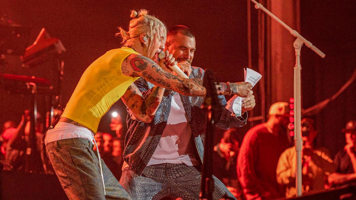 Machine Gun Kelly, left, and Travis Kelce read lyrics while performing the Beastie Boys’ “Fight for Your Right” at Kelce Jam at the Azura Amphitheater on Friday, April 28, 2023, in Bonner Springs.