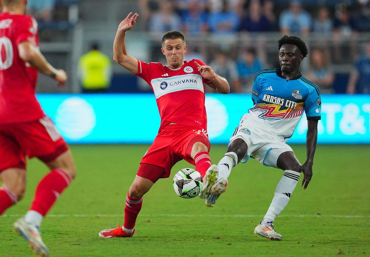 Sporting Kansas City forward Stephen Afrifa, right, challenges Chicago Fire FC defender Arnaud Souquet for the ball during Sunday night’s Leagues Cup match between the MLS foes at Children’s Mercy Park in Kansas City, Kan.