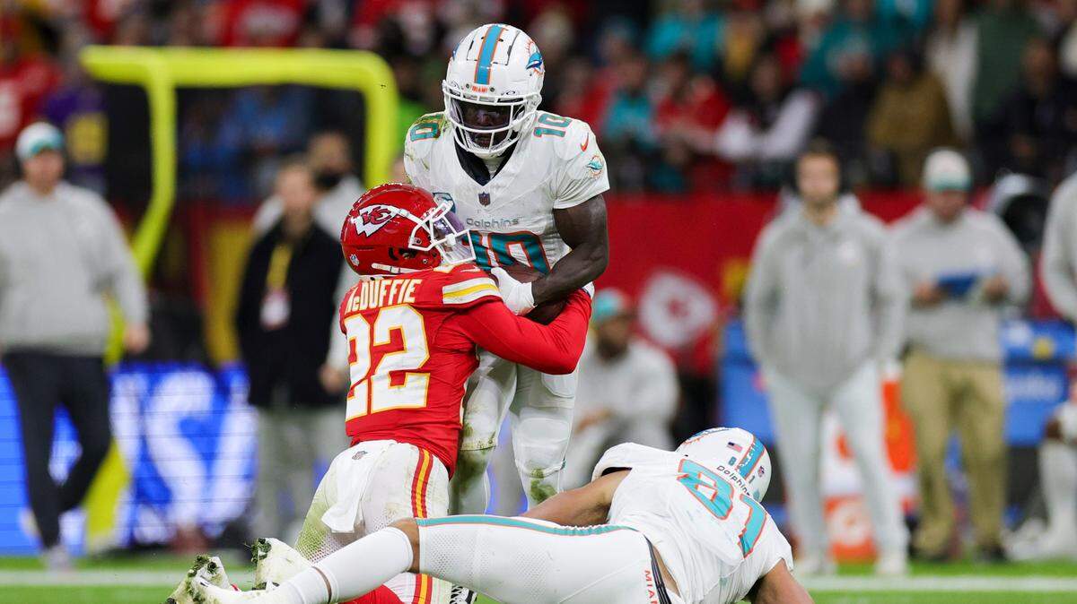 Kansas City Chiefs cornerback Trent McDuffie (22) forced a fumble by Miami Dolphins wide receiver Tyreek Hill (10) in the second quarter during an NFL International Series game at Deutsche Bank Park.
