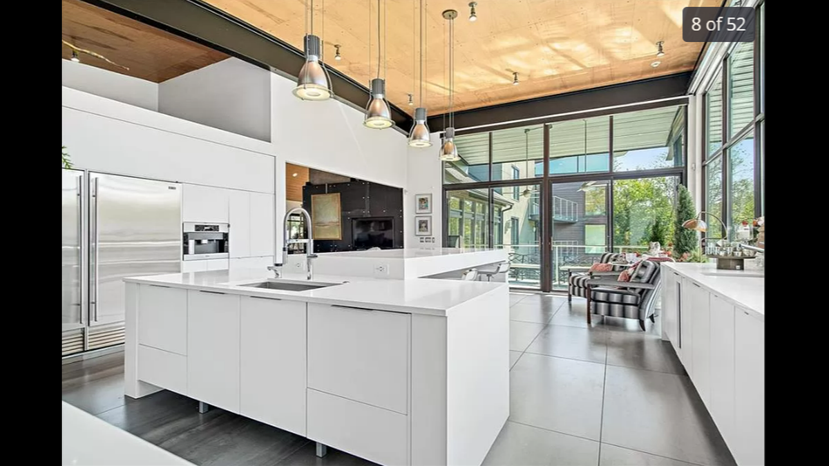 The floor-to-ceiling windows on the main level extend to the kitchen inside 14420 Mission Road in Leawood, giving you natural sunlight when you are cooking breakfast in the morning.