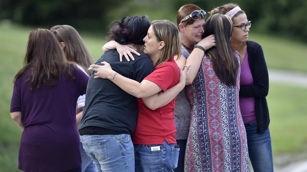 Family and friends gather near Longview Lake at East 129th Street and Raytown Road to find out what happened to their missing loved ones. Two bodies were found at Longview Lake Wednesday and police are investigating.