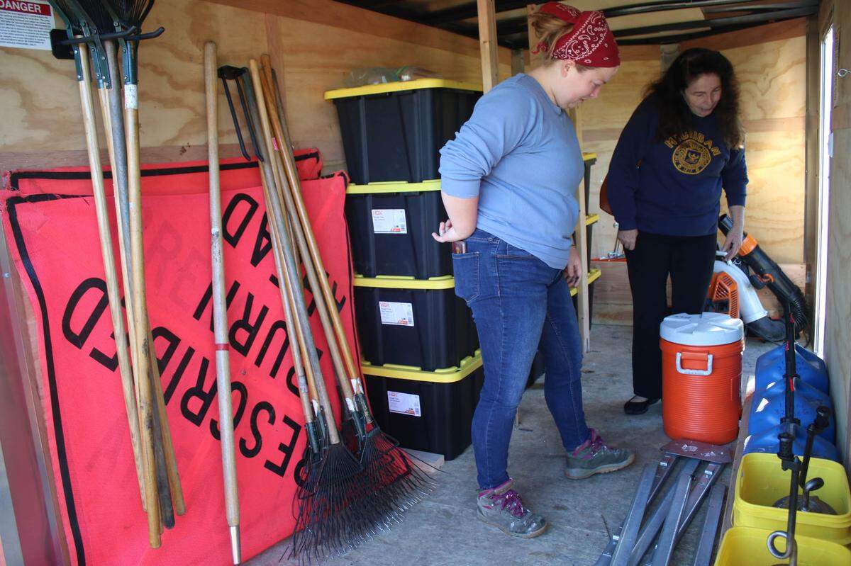 Gardner residents Lindsay Evans and Kathy Henehan check out some of the equipment Johnson County uses for its prescribed burns.