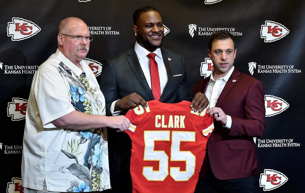 With Head Coach Andy Reid (left) and General Manager Brett Veach (right), the Kansas City Chiefs introduce Frank Clark, former Seattle Seahawks defensive end, at the Stram Theatre at the team’s training facility Friday, Apr. 26, 2019.