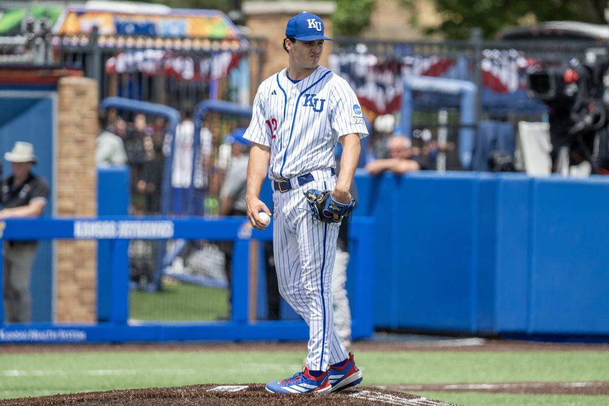 Kansas Jayhawks pitcher Dominic Voegele (12) looks over the field in the seventh inning against the Northeastern Huskies during an NCAA baseball tournament game at Hoglund Ballpark on Friday, May 29, 2026, in Lawrence.