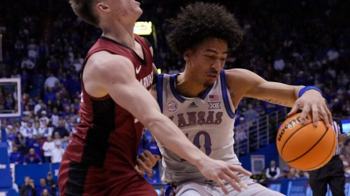 Harvard guard Denham Wojcik (55) fouls Kansas forward Jalen Wilson (10) during the first half on Thursday, Dec. 22, 2022, in Lawrence, Kan.