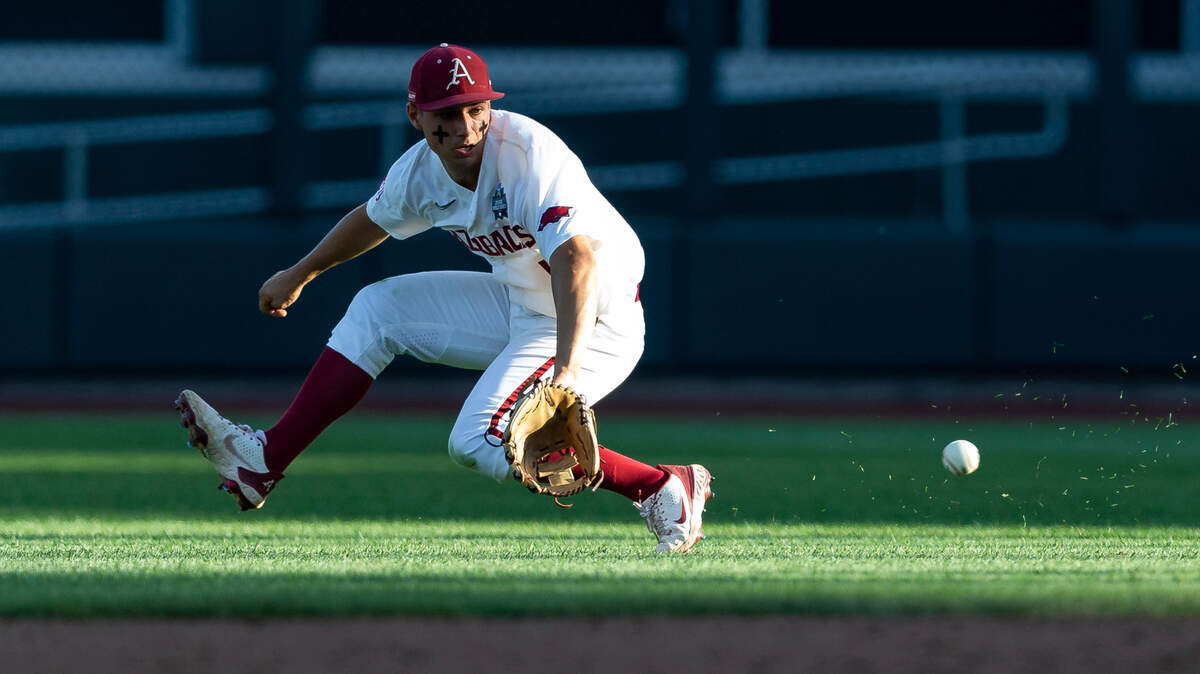 Arkansas second baseman Robert Moore fields the ball against Mississippi in the third inning during an NCAA College World Series baseball game, Monday, June 20, 2022, in Omaha, Neb. (AP Photo/John Peterson)
