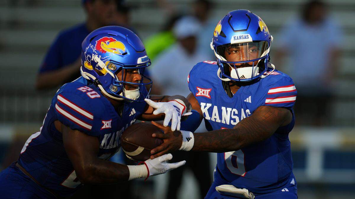 Kansas Jayhawks quarterback Jalon Daniels (6) hands off to running back Daniel Hishaw Jr. (20) during warmups before a game against the Missouri State Bears at David Booth Kansas Memorial Stadium on Sept. 1, 2023.