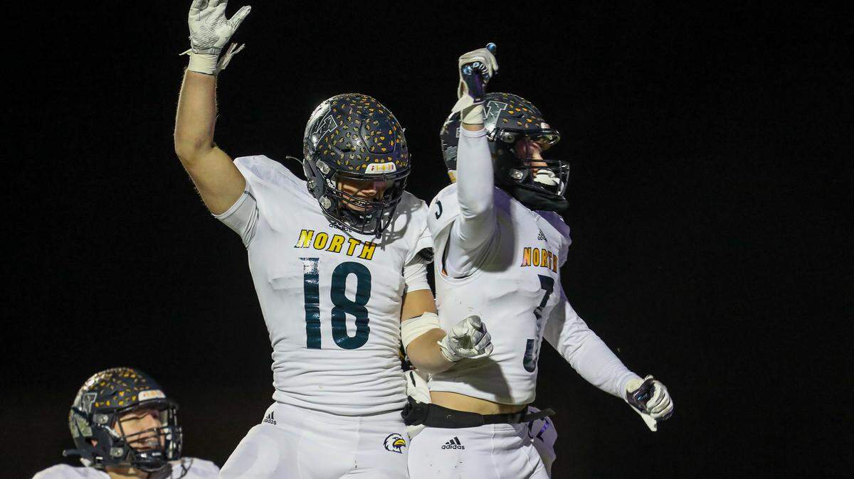 Liberty North’s Tate McGuire (3) celebrates his third-quarter touchdown with teammate Justis Braden during the Eagles’ Class 6, District 4 championship game against Park Hill South Friday night.