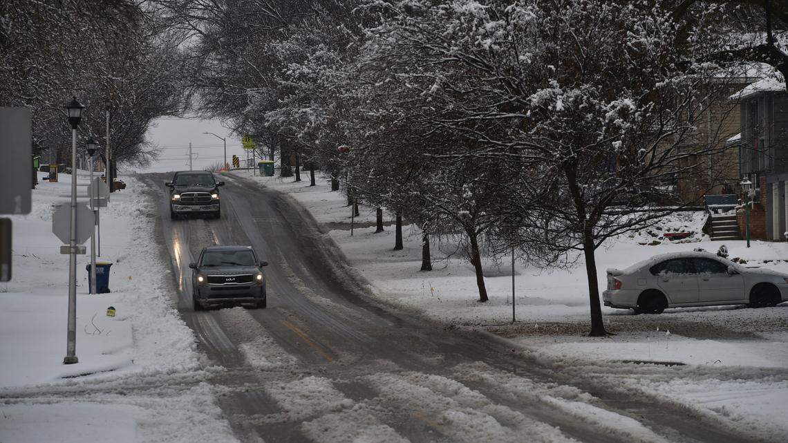 Drivers cautiously drive through a slushy 91st Street in Overland Park after a winter suprised the Kansas City area with a couple inches of wet, heavy snow Thursday morning. The snow had come to an end by 9 a.m.