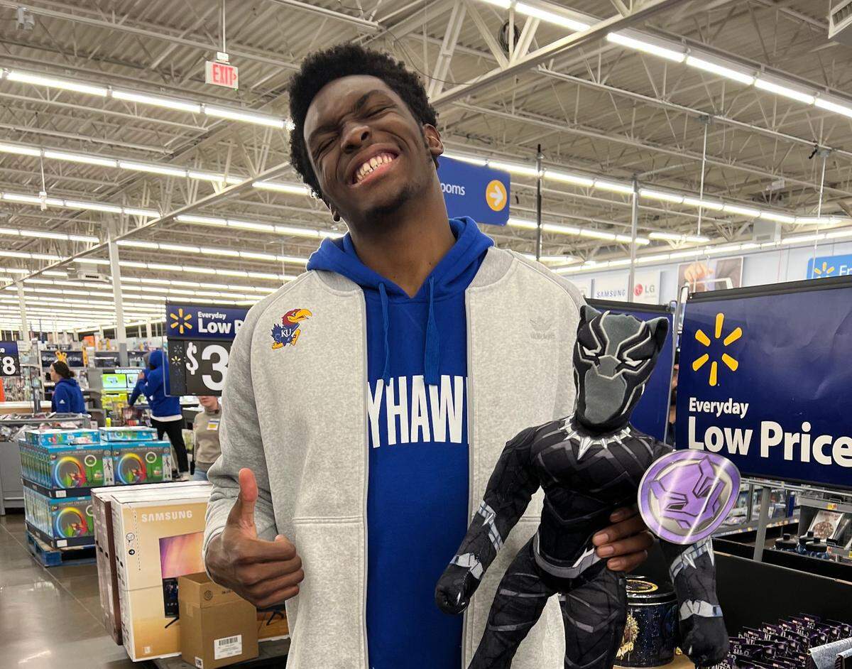 KU freshman Ernest Udeh had fun picking out Christmas gifts for an area family on Thursday night at Walmart.