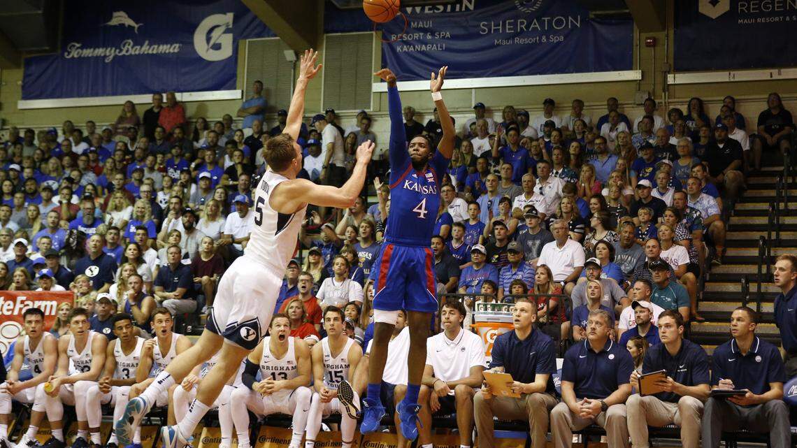 Kansas guard Isaiah Moss (4) attempts a three point shot over BYU guard Jake Toolson (5) during the first half of an NCAA college basketball game Tuesday, Nov. 26, 2019, in Lahaina, Hawaii. (AP Photo/Marco Garcia)