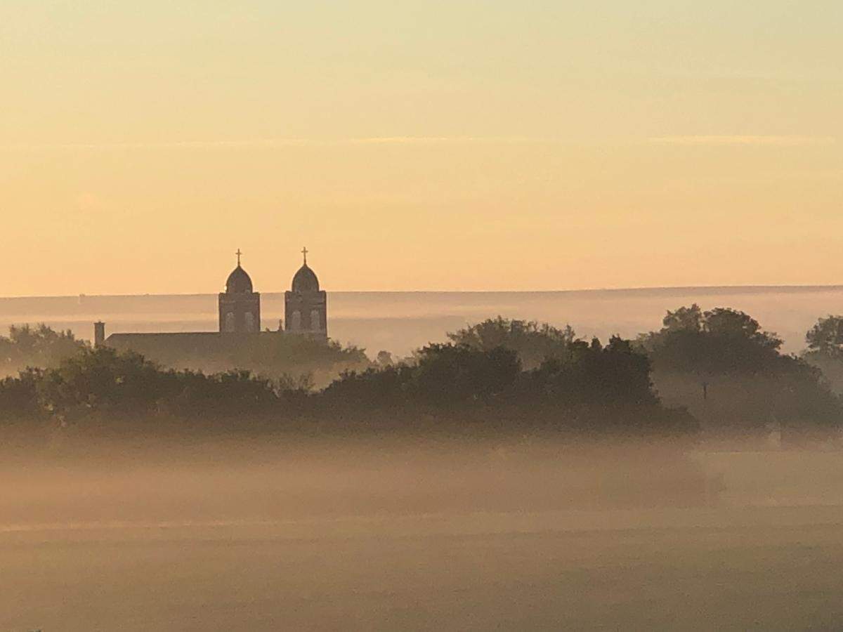 Kansas Flint Hills are stunning in every season. Sacred Heart Catholic Church near Paxico, Kansas. Foggy Morning, Sept 23, 2019