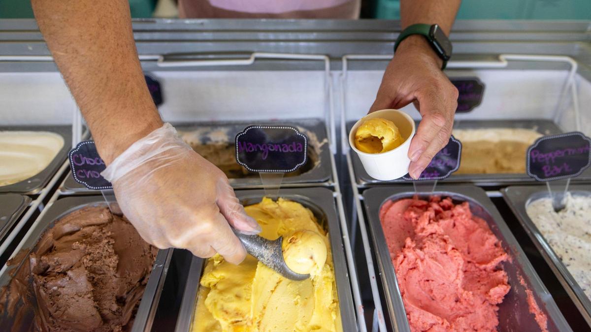 Curtis Jay, co-owner of the new Hey Sugar in Kansas City, Kansas, scoops a ball of Mangonada ice cream.