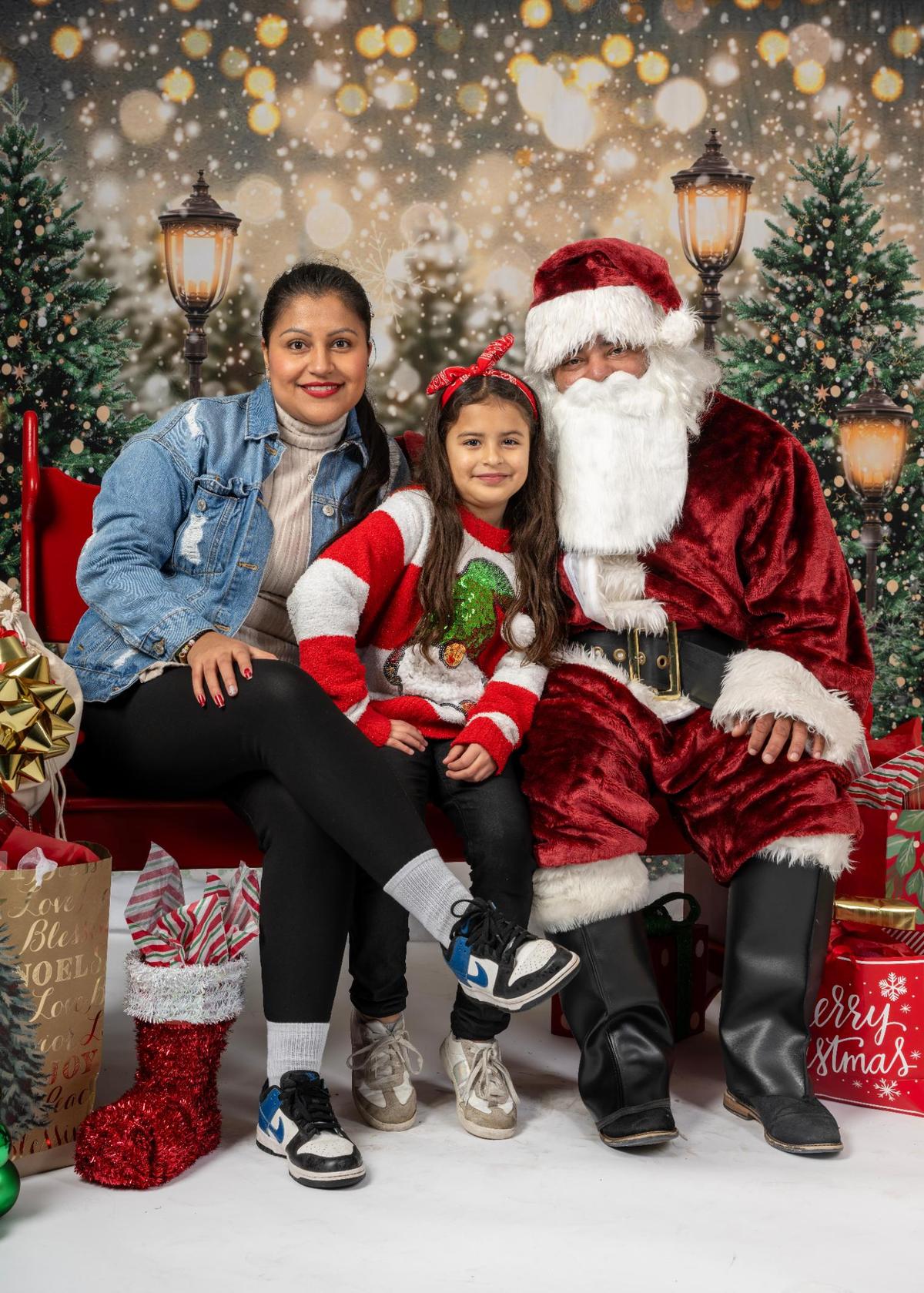 Monica Urrego, her daughter, Valery Urrego, and Santa Claus sat for a portrait at the Mattie Rhodes Center Northeast on Saturday, Dec. 13, 2024 in Kansas City.