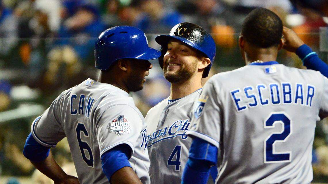 Kansas City Royals center fielder Lorenzo Cain (left) celebrates with teammates Alex Gordon (4) and Alcides Escobar (2) after scoring a run against the New York Mets in the 8th inning of Game 4 of the World Series at Citi Field on Oct. 31, 2015.