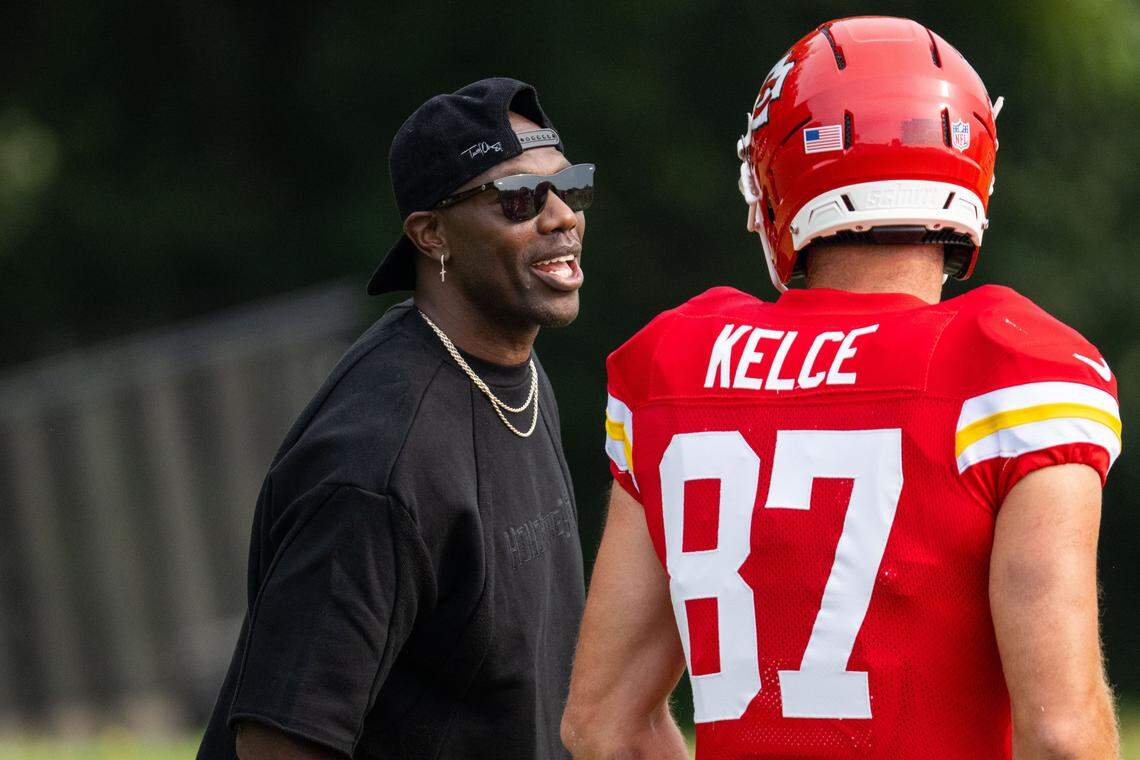 Former NFL wide receiver Terrell Owens talks with Kansas City Chiefs tight end Travis Kelce (87) at Chiefs Training Camp on Thursday, Aug. 7, 2025 in St. Joseph. Owens, who played for head coach Andy Reid when he coached the Philadelphia Eagles, attended training camp and interacted with several players and coaches.