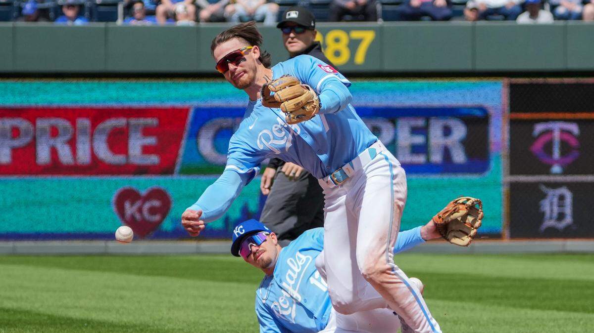 Kansas City Royals shortstop Bobby Witt Jr. (7) throws to first for the out while Nick Loftin (12) looks on against the Houston Astros in the fourth inning at Kauffman Stadium on April 11, 2024.