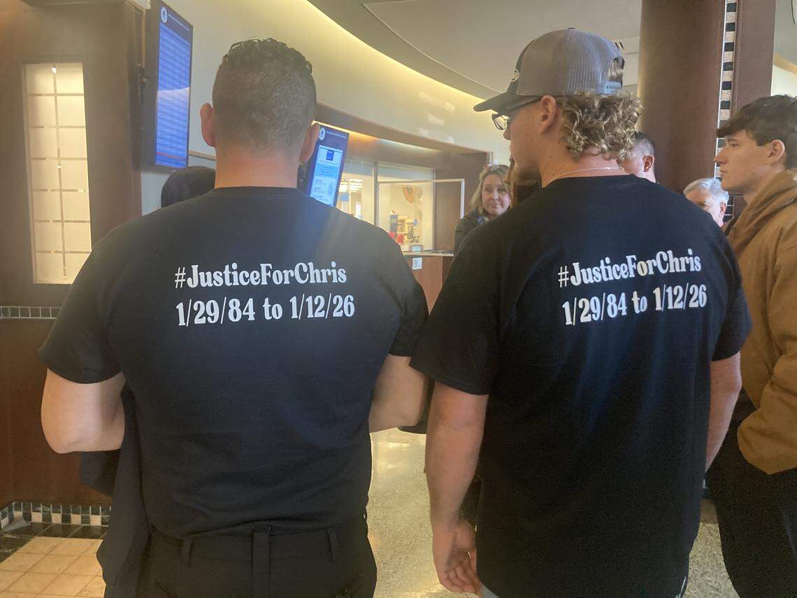 Stewart Wells and Trent Wells attend a bond hearing for Jeffrey Traviss King, a Kansas City man charged in the shooting death of their cousin, Christopher Cole Wells, 41, who was shot on Jan. 12. They wear T-shirts bearing their cousin’s name.