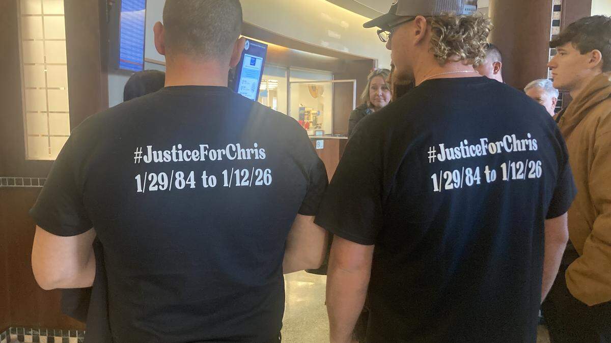 Steward Wells and Trent Wells attend a bond hearing for Jeffrey Traviss King, a Kansas City man charged in the shooting death of their cousin, Christopher Cole Wells, 41, who was shot on Jan. 12. They wear T-shirts bearing their cousin’s name.