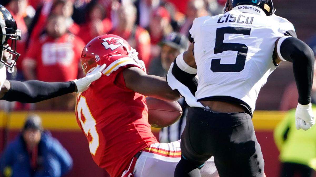 Chiefs wide receiver JuJu Smith-Schuster is driven to the turf after being hit hard by Jacksonville Jaguars safety Andre Cisco during Sunday’s game at GEHA Field at Arrowhead Stadium.