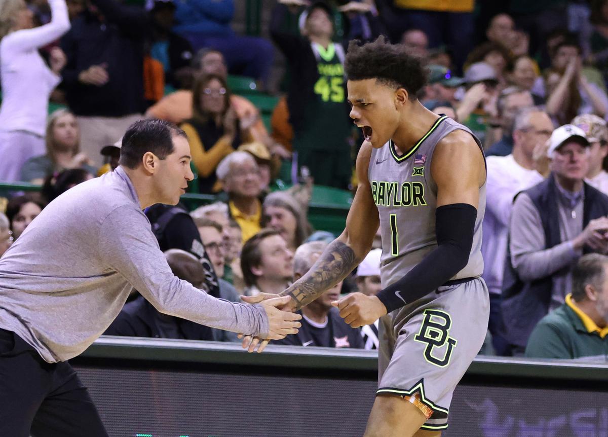 Baylor guard Keyonte George slaps hands with coach Scott Drew after a Bears score against Oklahoma State on Saturday, Jan. 14, 2023, in Waco, Texas.