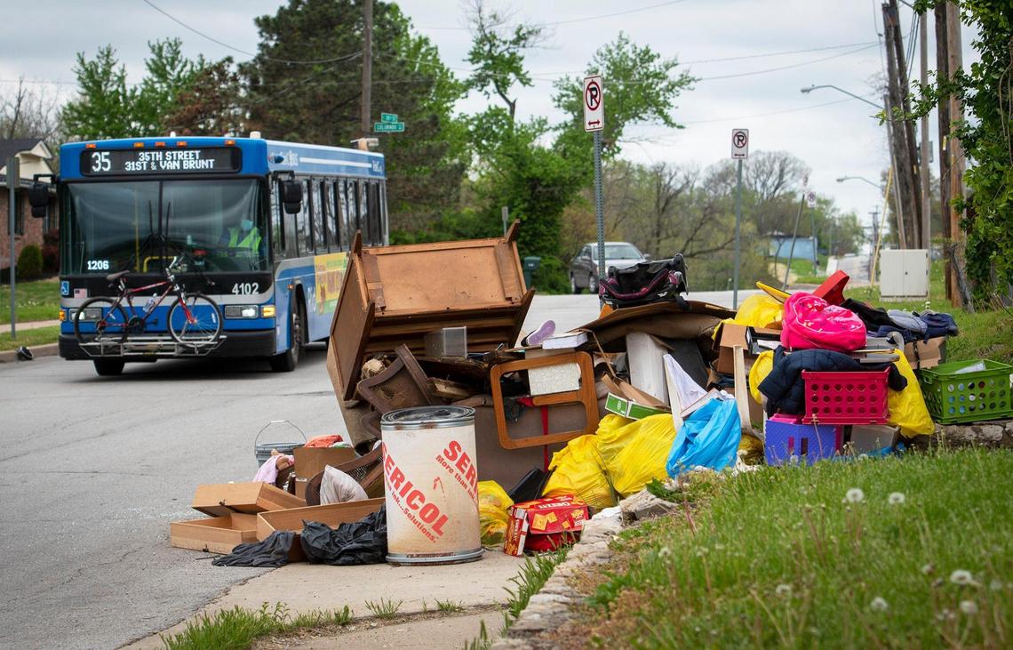 Household furnishings and trash litter the curb near East 35th Street and Hardesty Avenue.