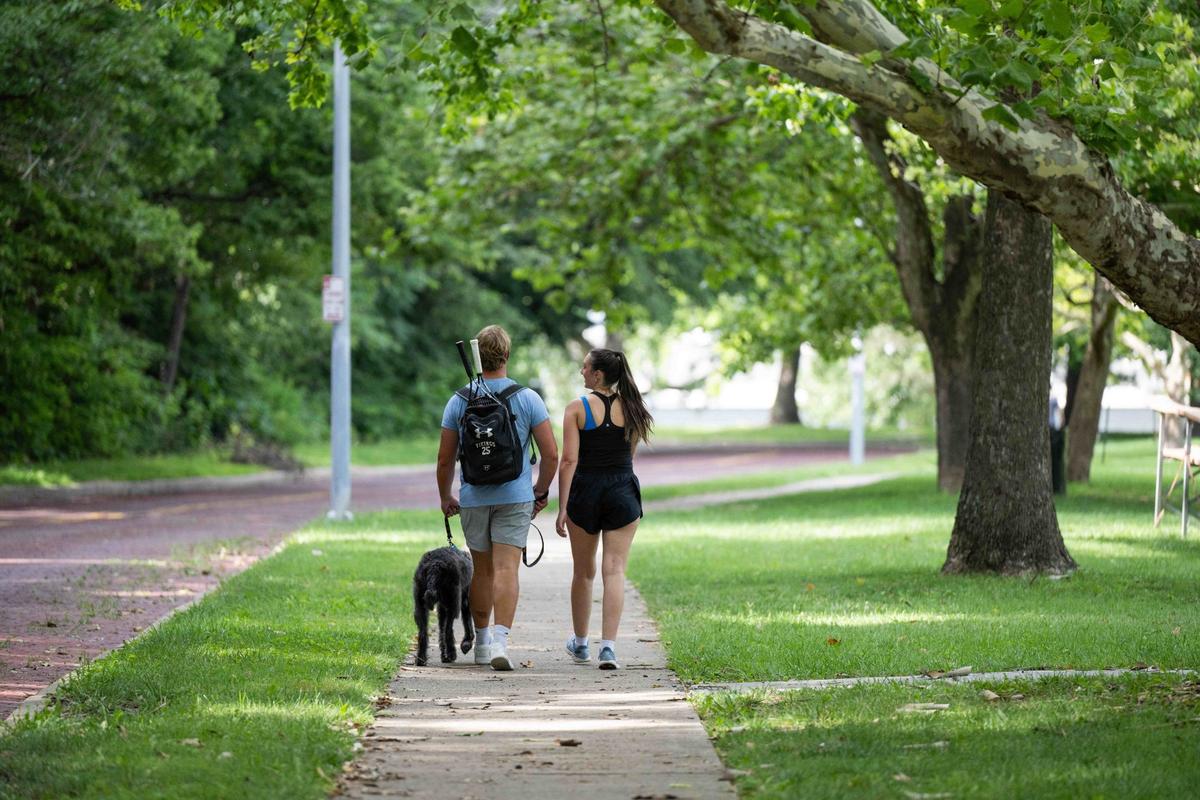 People walk along a path in Roanoke Park. With limestone outcroppings and thick woods, you’ll forget you’re in the city.