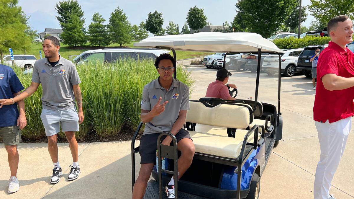 Kansas freshman Elmarko Jackson relaxes in a golf cart prior to the start of Monday’s Crimson and Blue Classic benefit golf tournament at the Jayhawk Club in Lawrence. Dajuan Harris, left and Mitch Lightfoot are also pictured.
