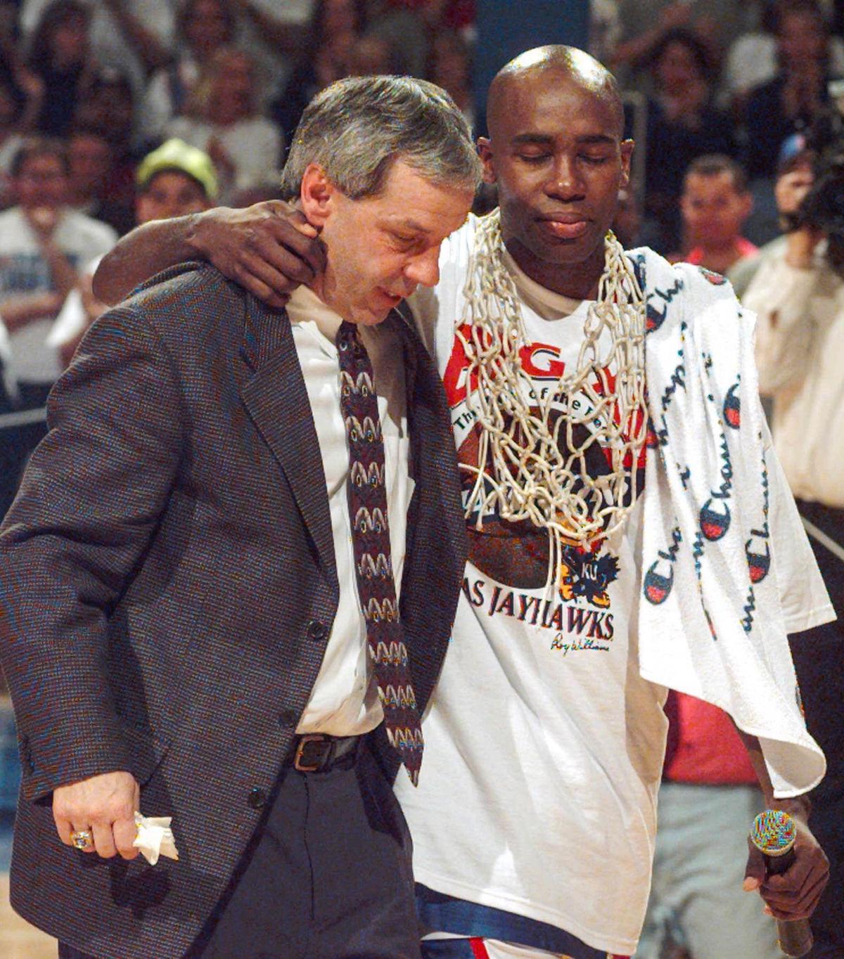 Kansas coach Roy Williams and Jacque Vaughn leave the court after a tearful tribute to the seniors who played their last home game Saturday, Feb. 22, 1997, in Lawrence, Kan. The ceremony took place after the team cut down a net in celebration of clinching the Big 12 conference trophy by beating Kansas State 78-58.