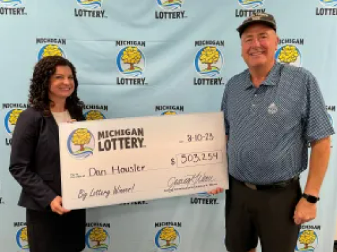 Dan Housler is given his oversized $503,254 check.