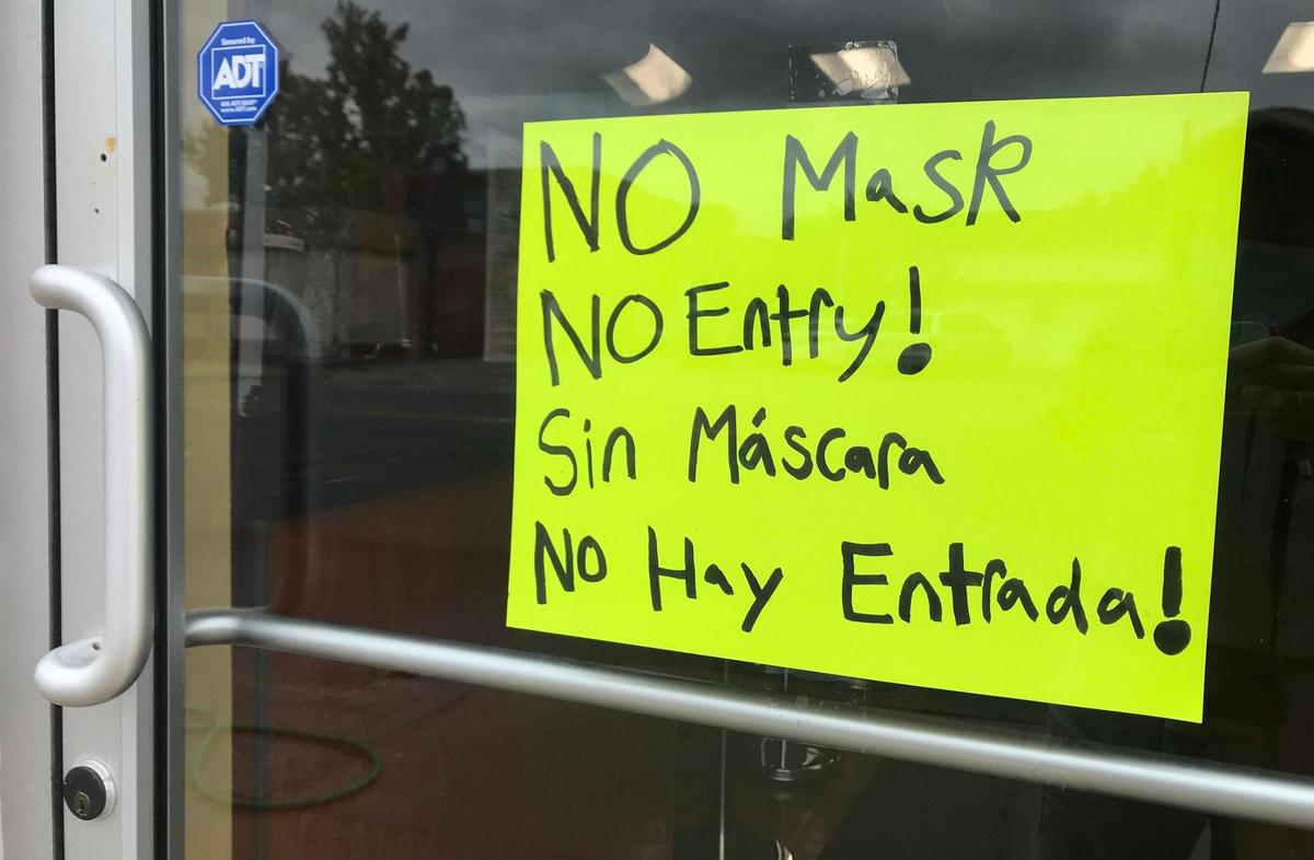 A sign in English and Spanish warns “No Mask, No Entry!” on the door of the Jade Dragon Express restaurant in Kansas City, Kansas. The Unified Government requires people to wear masks in public to help stop the spread of the coronavirus.
