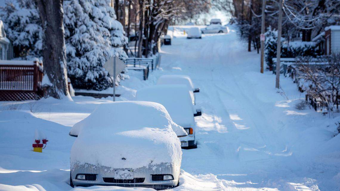 Snow covers cars and Blondo Street east of Northwest Radial Highway in Omaha, Neb., on Tuesday, Jan. 26, 2021. The Omaha area recorded almost 12 inches of snow the day before..