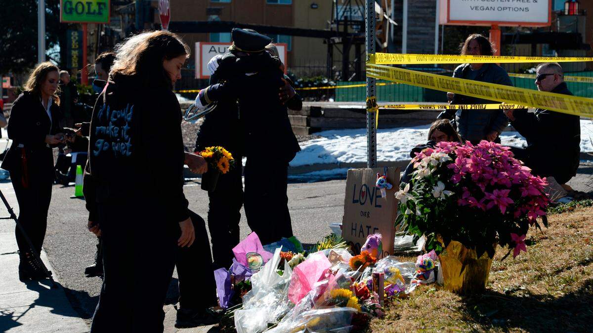Community members grieve near a gay nightclub in Colorado Springs, Colo., Sunday, Nov. 20, 2022, where a shooting occurred late Saturday night. A 22-year-old gunman opened fire in a gay nightclub, killing at least five people and leaving multiple others injured before he was subdued by “heroic” patrons and arrested by police who were on the scene within minutes, authorities said Sunday. Kansas Citians are planning a vigil for the victims.