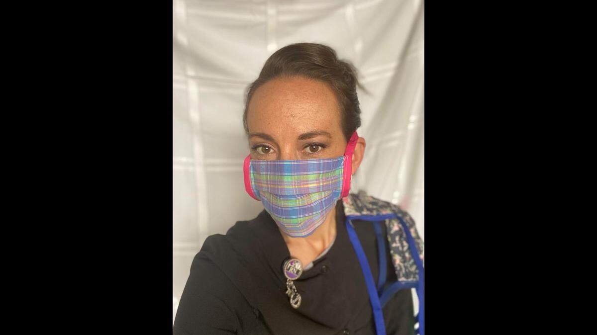 Registered nurse Brandi Thomas-Astry of eastern Jackson County models one of the cloth masks she made for her colleagues at a local oncology clinic.