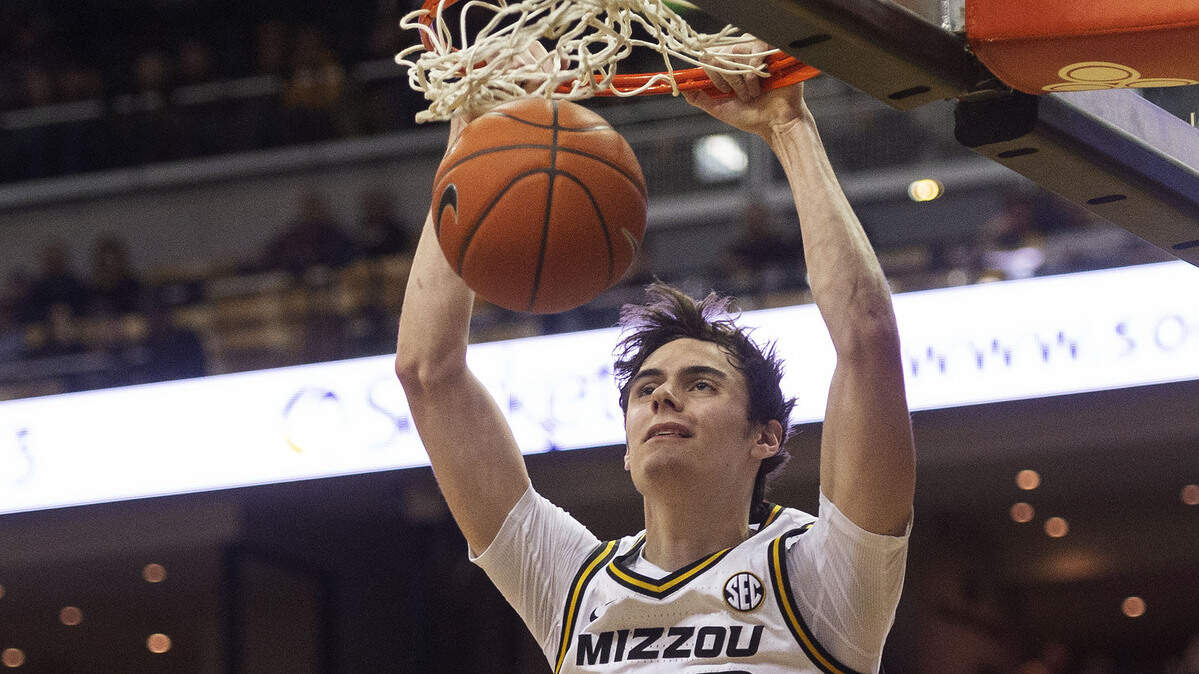 Missouri’s Parker Braun, top, dunks the ball over Mississippi’s Breein Tyree, left, during the second half of an NCAA college basketball game Tuesday, Feb. 18, 2020, in Columbia, Mo. Missouri won 71-68.(AP Photo/L.G. Patterson)