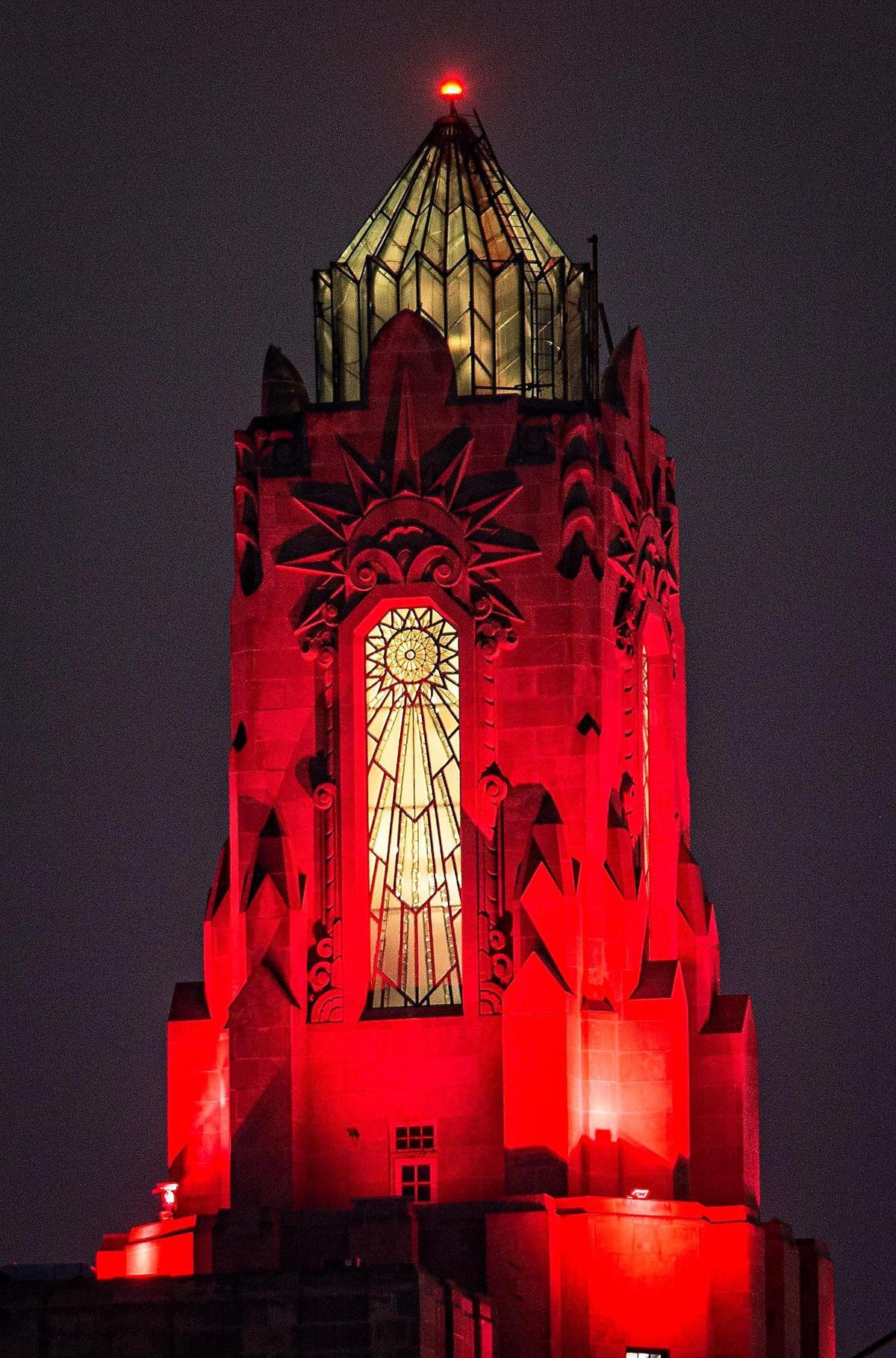 The art deco top of the Power and Light building glows red to celebrate the success of the Kansas City Chiefs.