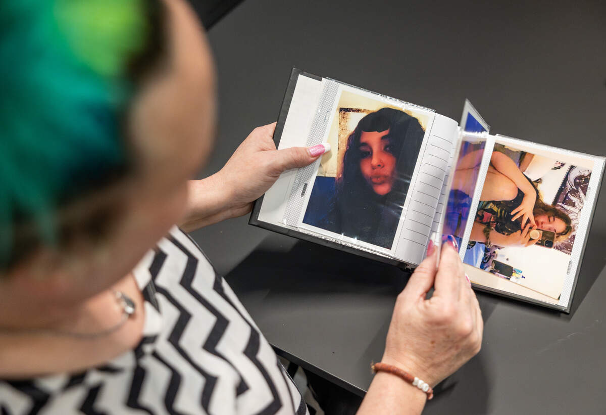 Jennifer Brown pages through a photo album containing memories of her daughter, Karla, who was killed in a shooting in November.