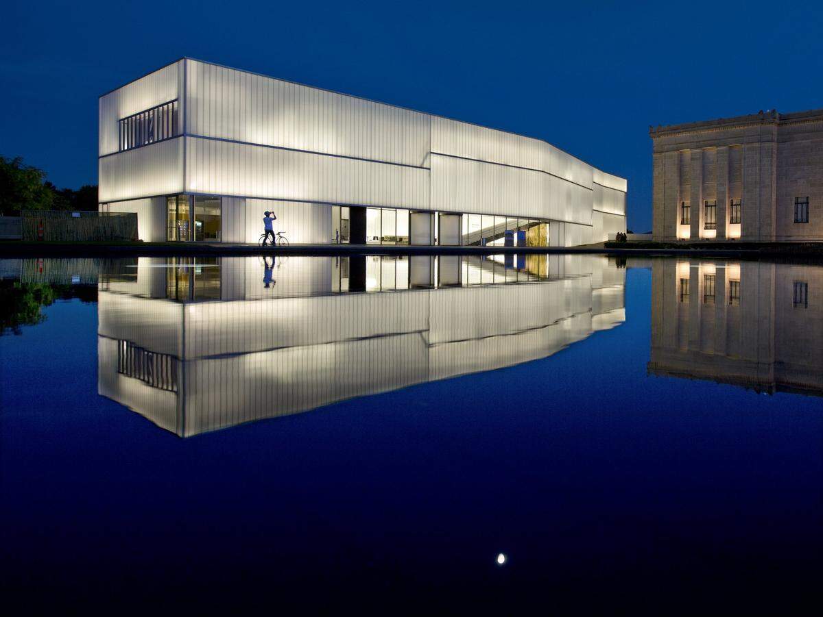 The Steven Holl designed Bloch Building addition to the Nelson-Atkins Museum of Art opened on June 9, 2007. It and the original 1930s Beaux-Arts building are seen on Tuesday evening, June 6, 2017, reflected in a pool atop the museum’s parking garage.
