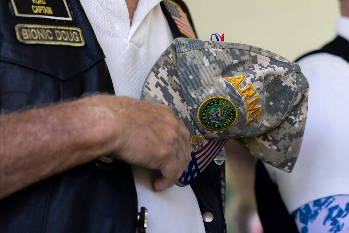 Member of the American Legion ____ holds their hat over their heart during the National Antihuman at St. Michael's Veterans Center on Monday, June 29, 2026. Valor House, the final residential building in St. Michael's Veterans Center's original campus master plan, adds 62 affordable apartment homes, expanding the campus to 179 permanent housing units for veterans experiencing homelessness or disabilities in the Kansas City area.