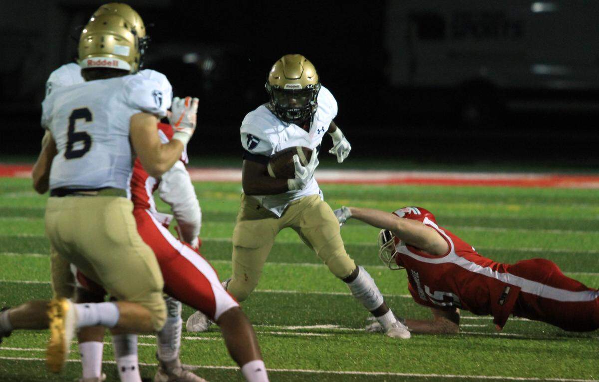 St. Thomas Aquinas running back Tank Young tried to work his way down field against Bishop Miege on Friday night.
