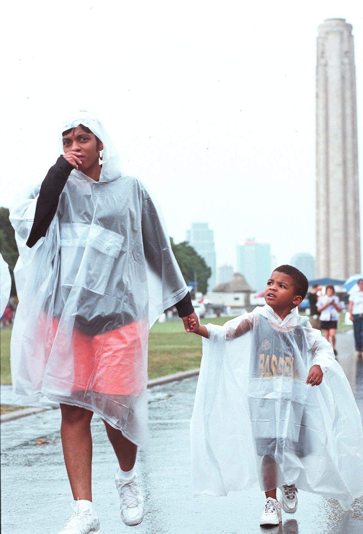 A mother and son walk in the rain at the 1999 Spirit Festival.