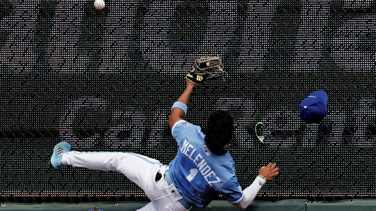 Kansas City Royals right fielder MJ Melendez hits the fence as he tries to catch an RBI triple hit by Los Angeles Angels’ Phil Gosselin during the fifth inning of a baseball game Wednesday, July 27, 2022, in Kansas City, Mo. (AP Photo/Charlie Riedel)
