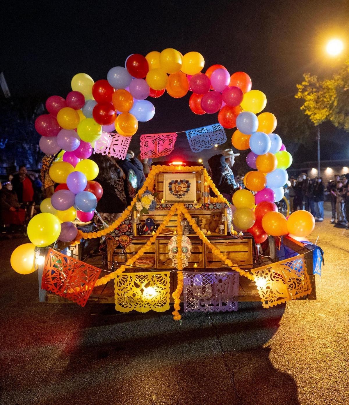A float features an altar dedicated to someone who has died during the Dia de los Muertos parade hosted by the Central Avenue Betterment Association on Saturday in Kansas City, Kan.