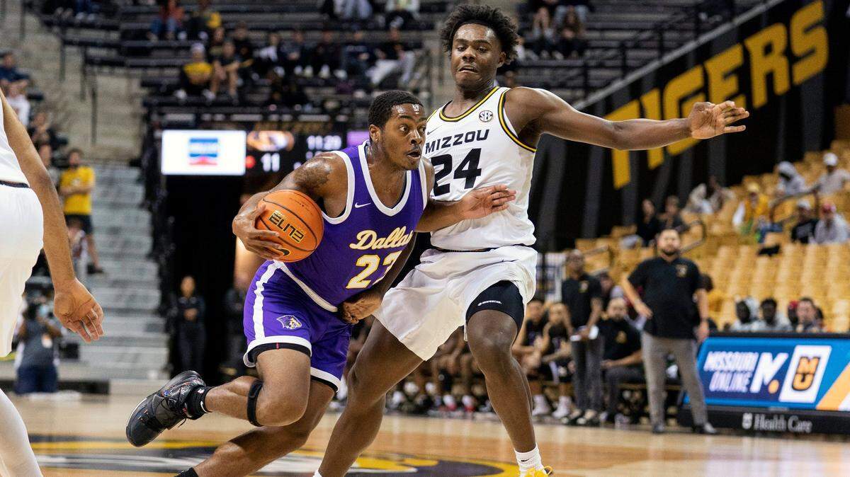 Paul Quinn’s Bruce Scott, left, drives past Missouri’s Kobe Brown, right, during the first half of an NCAA college basketball game Monday, Nov. 29, 2021, in Columbia, Mo. (AP Photo/L.G. Patterson)