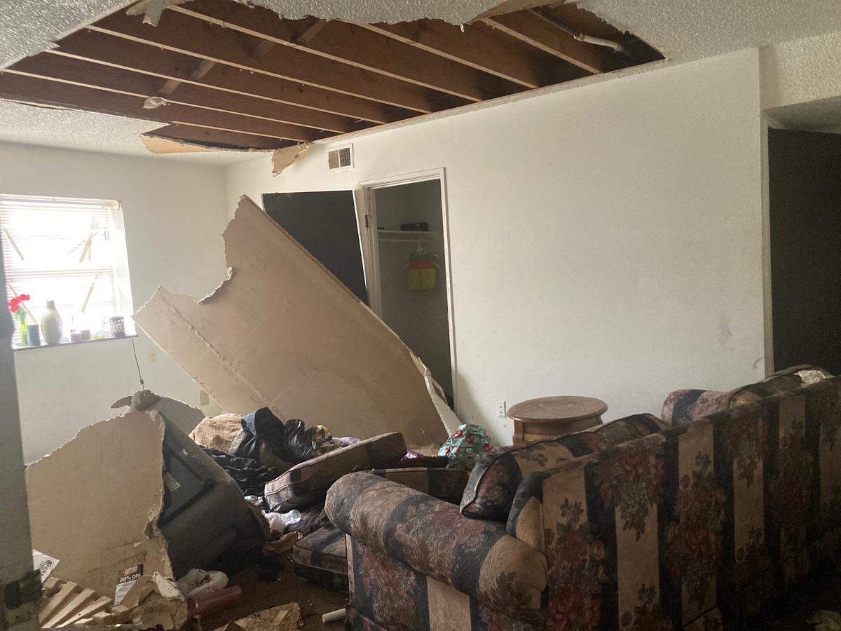 An abandoned basement apartment at the Cloverleaf Apartments where water damage from above caused the ceiling to collapse on a living room couch.